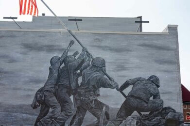 A mural on a wall at Amherst's Patriots Park depicting the Marines raising an American flag during the battle of Iwo Jima