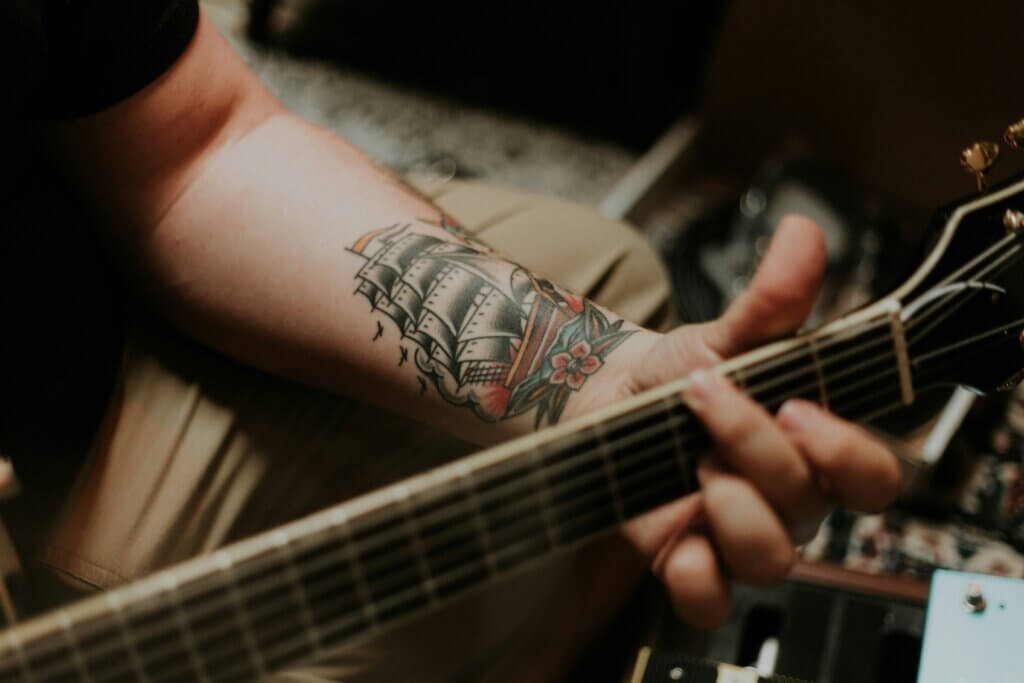 A musician picks an electric guitar