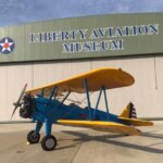 an airplane in front of a hangar at the Liberty Aviation Museum